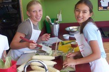 Small_2_girls_smiling_preping_food